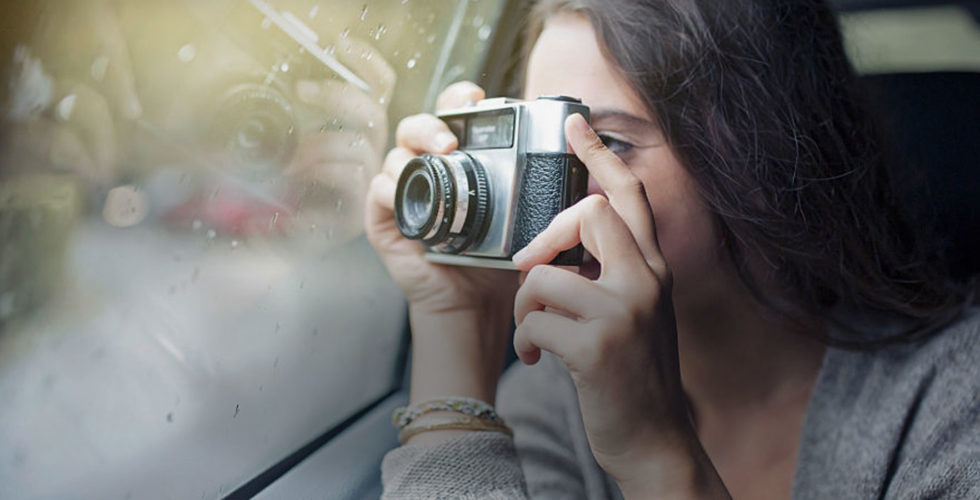 Woman taking photo through a window. Asentiv slide